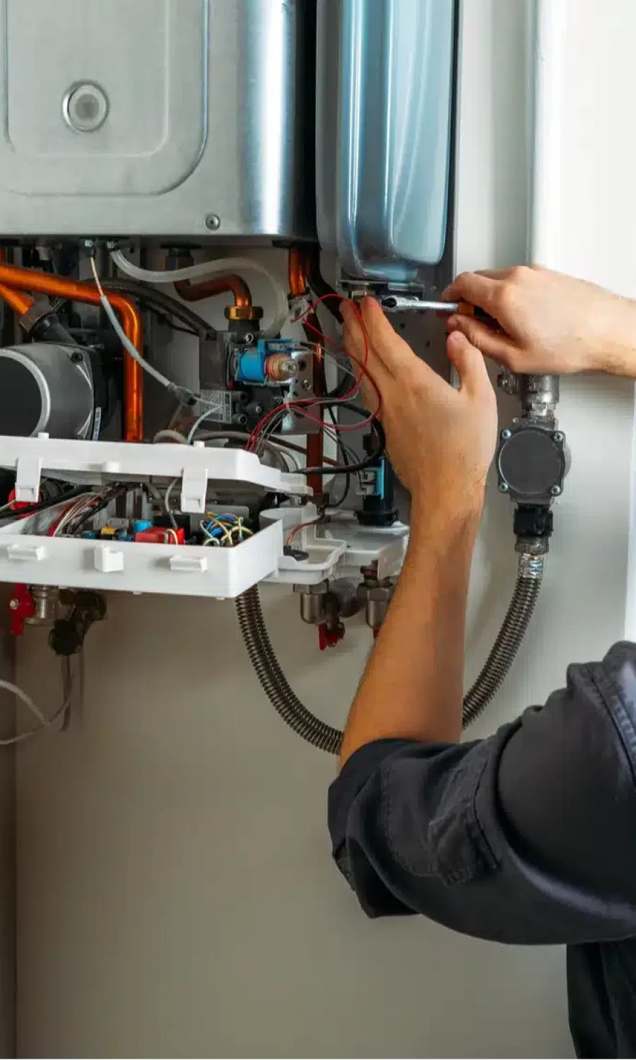plumber-attaches-trying-fix-problem-with-residential-heating-equipment-repair-gas-boiler Types of boiler we install in Manchester